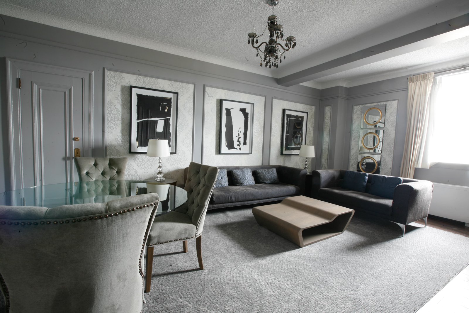 Fort Garry Hotel luxury interior design by Parishi Yagnik Toronto — living room with grey velvet chairs and chandelier