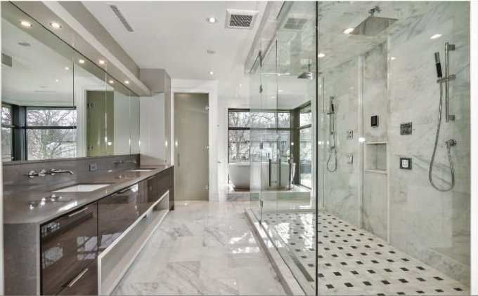 Ensuite bathroom with a long vanity, stone-look floor and glass shower